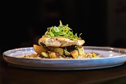 a plate with a piece of food on a table at Ventura Santa Teresa in Santa Teresa Beach