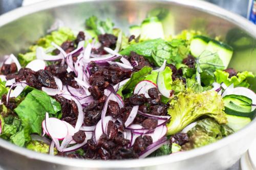 a bowl of salad with raisins and other vegetables at Ventura Santa Teresa in Santa Teresa Beach