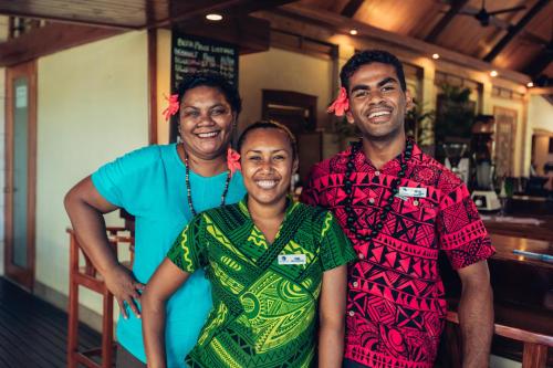 a group of three people posing for a picture at Koro Sun Resort & Rainforest Spa in Savusavu