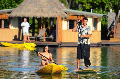 a man and a woman on kayaks in the water at Koro Sun Resort & Rainforest Spa in Savusavu
