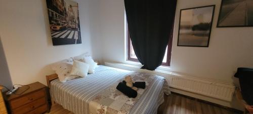 a woman sitting on a bed in a bedroom at Central Belgium in Brussels