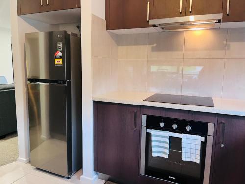 a kitchen with a refrigerator and a stove at Tranquility in Lakes Entrance