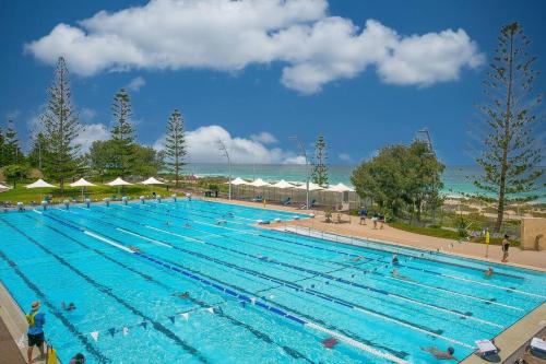 a large swimming pool with many people in it at Seaside Bliss in Perth