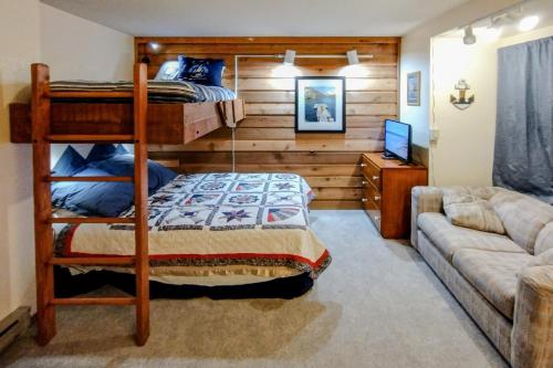 a bedroom with a bunk bed and a couch at Lake Therapy in Lakeshore