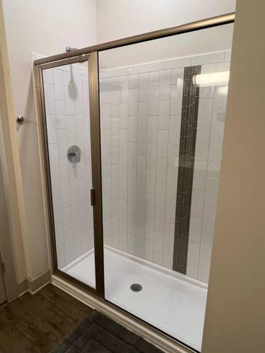 a shower with a glass door in a bathroom at Luxury Executive 2 Bedroom/2 Bathroom Boutique Apt in Charlotte