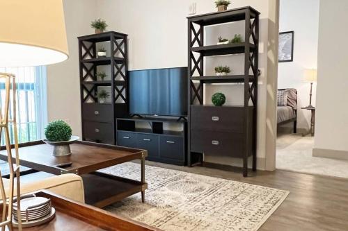 a living room with a black book shelf at Luxury Executive 2 Bedroom/2 Bathroom Boutique Apt in Charlotte