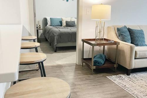 a living room with a couch and a bed at Luxury Executive 2 Bedroom/2 Bathroom Boutique Apt in Charlotte