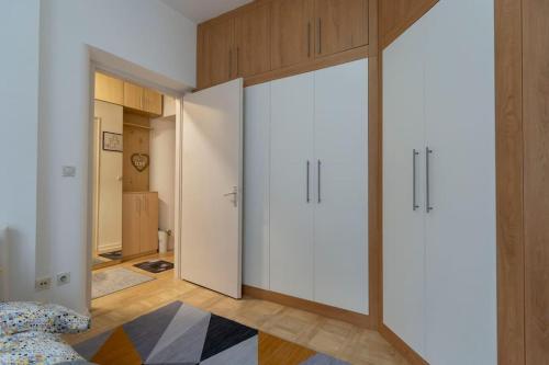 a bedroom with white cabinets and a large sliding door at Train 23 in Belgrade