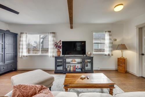 a living room with a tv and a coffee table at Colorado Springs Home Balcony with Mountain Views! in Colorado Springs