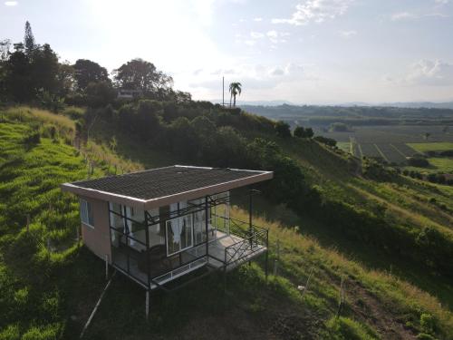 a small house on top of a hill at Finca Maratón Alto in Calarcá