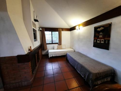 a room with two beds and a window at Terrazas del Venado in La Cumbre