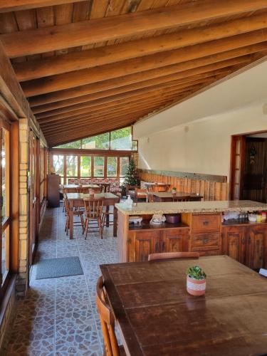 a large kitchen with wooden cabinets and a table at Pousada dos Quiosques in Viamão