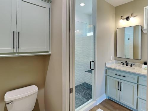 a bathroom with a shower and a toilet and a sink at Pescadors Paradise in Galveston