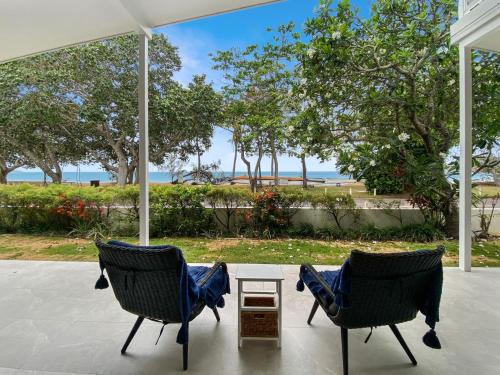 two chairs on a porch with a view of the ocean at Casa Siboney in Horseshoe Bay