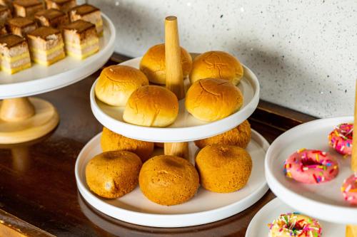 a plate of buns and other pastries on a table at Wuyu Hotel - Chongqing Jiangbei Airport & Light Rail in Chongqing