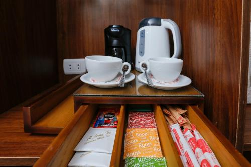 a shelf with two cups and a coffee maker at Sky Pyramids View Inn in Cairo