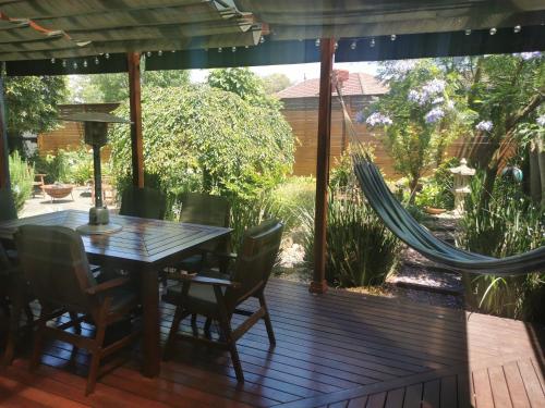 a patio with a table and chairs on a deck at Peaceful House In Mill Park Melbourne in Mill Park