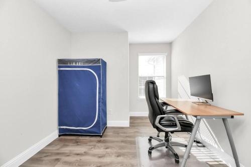 an office with a desk and a blue water heater at Tranquil 4-BR Oasis With Pool & Backyard Bliss! in Cypress