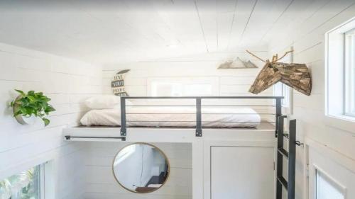 a room with a bunk bed and a mirror at 108 Tiny House Bradenton in Bradenton