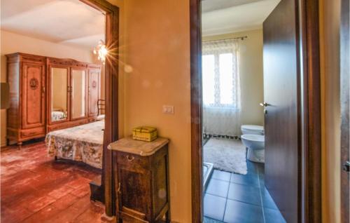 a room with a bedroom with a bed and a mirror at Amazing Apartment In Montegrosso Dasti With Kitchen in Montegrosso dʼAsti