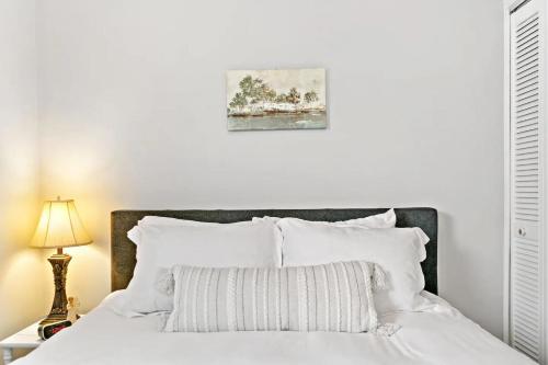 a white bedroom with a bed with white pillows at 127 Oakwood Hills in Oakwood Hills