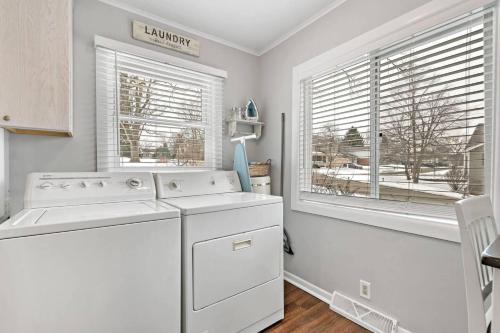 a kitchen with a washer and dryer and two windows at 127 Oakwood Hills in Oakwood Hills