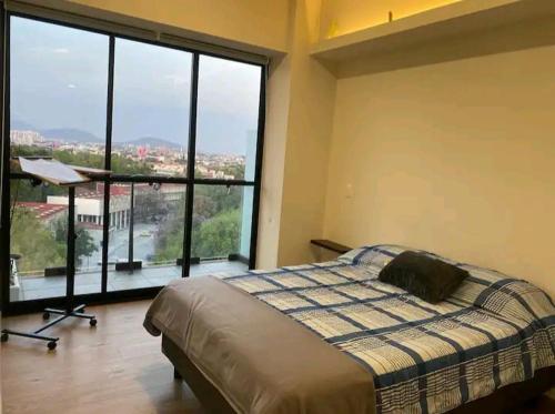 a bedroom with a bed and a large window at Vista Mágica Cdmx 1 in Mexico City