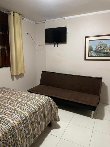 a bedroom with a bed and a flat screen tv at Hostal Alborada in Cajamarca
