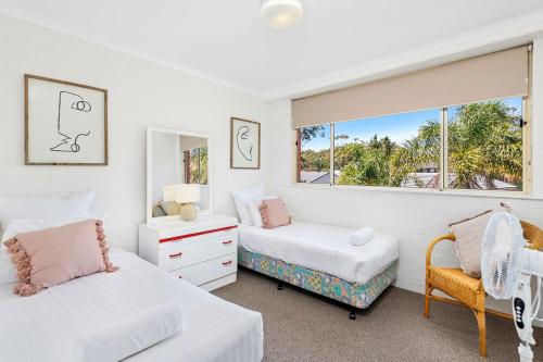 a bedroom with two beds and a window at Seaspray Unit 3 4 Intrepid Close in Nelson Bay