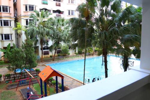 a view of a swimming pool from a balcony at Kuhara Court Apartment Suite in Tawau