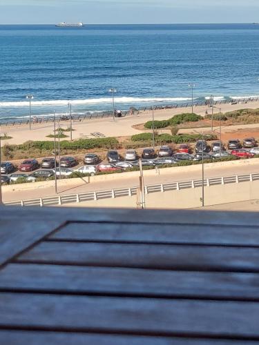 a view of a beach with cars and the ocean at modern apartment opposite the Hassan2 mosque, very well equipped and stylish, 85 m² with gym and direct sea view with underground garage. (couple of Arab origin without marriage certificate will be refused) in Casablanca