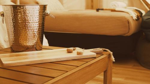 a wooden table with a cutting board on a table at The Barn Cabins & Camp in Marahau