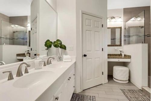 a white bathroom with a sink and a mirror at 363 Marco Island in Marco Island
