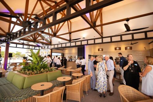 a group of people standing in a restaurant at Mercure Darwin Airport Resort in Darwin