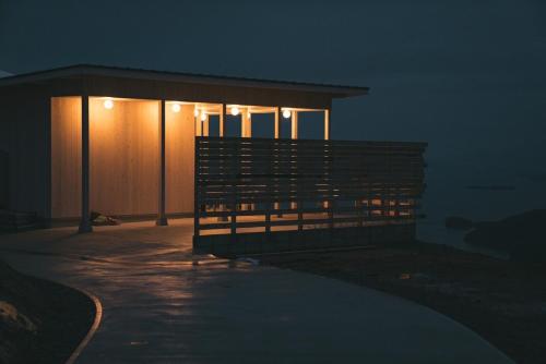 a house with lights on the side of it at night at Flat Glamping Nagasaki in Nagasaki