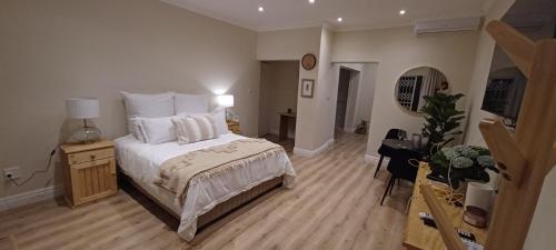 a bedroom with a bed and a television in it at Millwood House in Durban