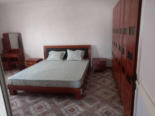 a bedroom with a bed with two pillows on it at RESIDENCE YATOO in Nouakchott