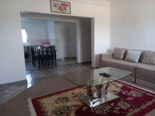 a living room with a couch and a glass table at RESIDENCE YATOO in Nouakchott