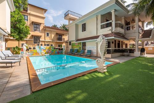 a swimming pool in the backyard of a house at The Ultimate Staycation Goa - 10BHK in Calangute