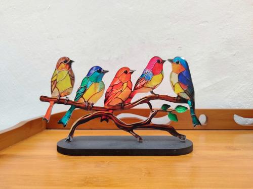 four colorful birds sitting on a branch statue at SS Ipoh Comfort Homestay - Taman Bertuah in Ipoh