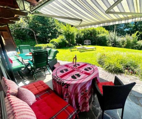 a patio with a table and chairs on a patio at Gäste Residenz Happy Kitz in Kitzbühel