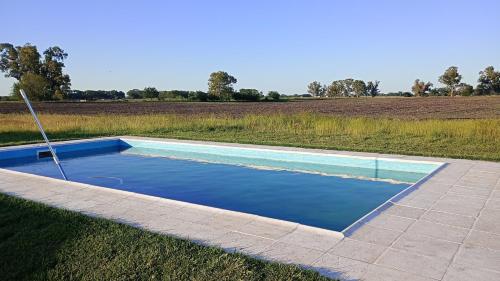 a swimming pool in the middle of a field at El Resueyo de Saladillo in Saladillo