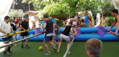 a group of people playing in a playground at Le Esperidi Camping Ecoresort in Marina di Bibbona