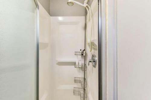 a shower in a bathroom with a glass door at All Points' End in Naples