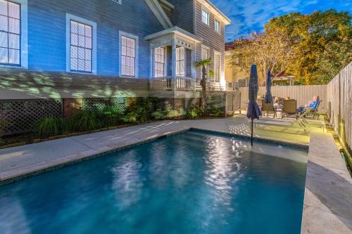 a swimming pool in front of a house at Coastal Cottage with Pool - Restoring Galveston in Galveston