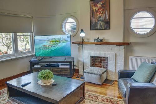a living room with a couch and a tv at Stylish Family Friendly Escape in Ballarat