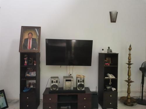 a living room with a flat screen tv on a wall at Kandy ambuluwawa mount villa in Angammana