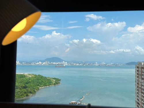 a view of the ocean from an airplane window at New Comfy Urban Suite Homestay at Georgetown for family by Urban Staycations LOD in Jelutong
