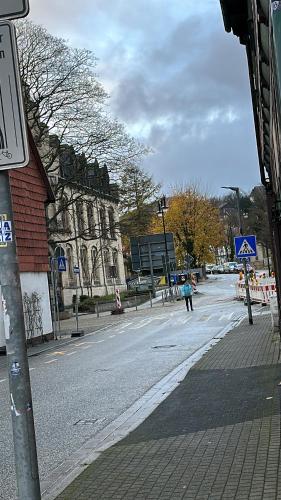 a person walking down a street next to a building at Ferienwohnung am Westerntor Jule inkl Parkplatz in Wernigerode