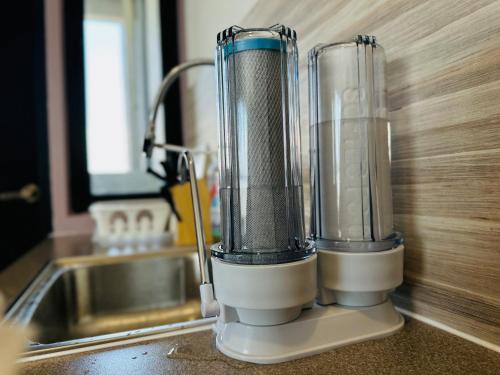 a blender sitting on a counter next to a sink at New Comfy Urban Suite Homestay at Georgetown for family by Urban Staycations LOD in Jelutong